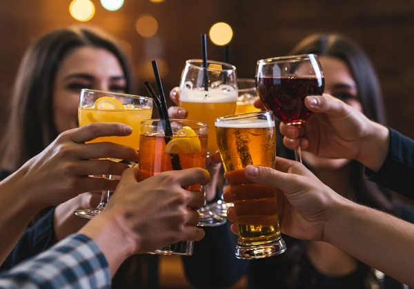 People toasting with drinks during a party game.